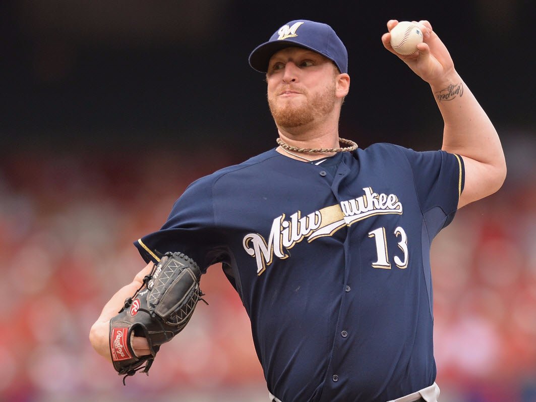 Milwaukee Brewers closer tore a ligament in his knee taking a shoe off